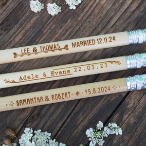 Personalized mini golf pencils, used for wedding favors and decorations at country style wedding, with white eraser, on wooden table with decorative flowers. An excellent gift for guests and all your loved ones.