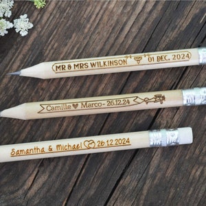 Personalized mini golf pencils, used for wedding favors and decorations at country style wedding, with white eraser, on wooden table with decorative flowers. An excellent gift for guests and all your loved ones.