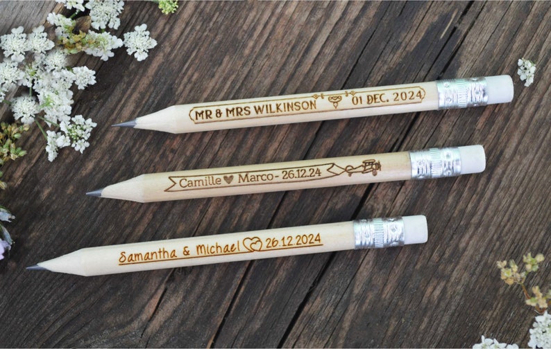 Personalized mini golf pencils, used for wedding favors and decorations at country style wedding, with white eraser, on wooden table with decorative flowers. An excellent gift for guests and all your loved ones.