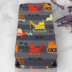 May include: A blue and gray fabric with a repeating pattern of construction vehicles and the text "You Dig It?", "Can You Dig It?", "On The Move", "Dig Dig!" and "Loading..."