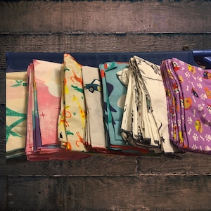 A set of 24 Randomly Selected Printed Daycare cot sheets standard size 52x22 or Toddler size 40 X 22 elastic all 4 sides