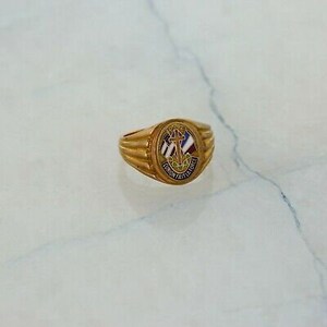 May include: Gold ring with a blue, white, and red enamel design featuring a cross, anchor, and the words "UNION FAIT LA FORCE".