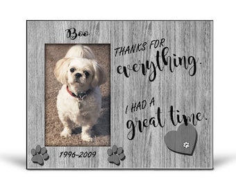 May include: A gray wooden picture frame with a white dog in the photo. The frame has the text "Boo" at the top, "THANKS FOR EVERYTHING. I HAD A GREAT TIME." in the right corner, and "1996-2009" at the bottom.