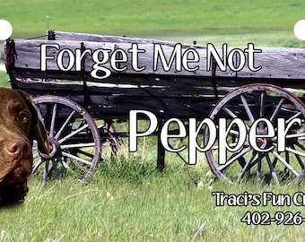 May include: A brown dog with a white collar sits in front of an old wooden wagon with wheels. The wagon has the text "Forget Me Not" and "Pepper" on it. The text "Traci's Fun Creations" and a phone number are also visible.