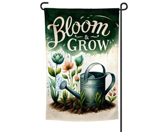 May include: A green garden flag with the text "Bloom & Grow" in white lettering. The flag features a watercolor-style illustration of a watering can pouring water onto a bed of flowers.