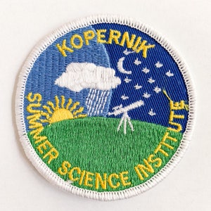 May include: A white embroidered patch with a blue and green background. The patch features a yellow sun, a white cloud with rain, a telescope, and a crescent moon with stars. The text "Kopernik Summer Science Institute" is embroidered in yellow around the edge.