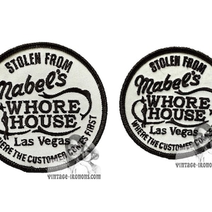 May include: Two white, round, embroidered patches with black stitching. The patches read "Stolen from Mabel's Whore House, Las Vegas, Where the Customer Comes First".