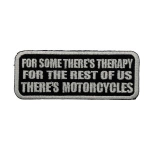 May include: A rectangular embroidered patch with a black background and a white border. The text in white capital letters reads: FOR SOME THERE'S THERAPY FOR THE REST OF US THERE'S MOTORCYCLES. The patch features a clean, stitched edge finish.