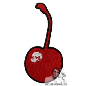 May include: Red embroidered iron-on patch of a cherry with a white skull inside.