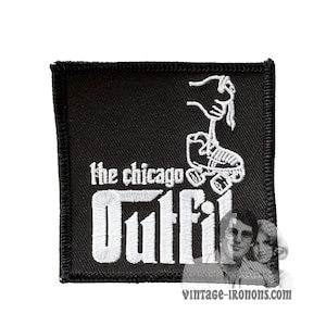 May include: Black embroidered patch with white text that reads "The Chicago Outfit" and a white roller skate graphic.