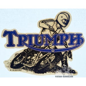 May include: A vintage Triumph motorcycle sticker showing a rider in a helmet, leaning into a turn. The word "TRIUMPH" is in blue, arched over the motorcycle. The sticker has a light brown background with black and blue details.