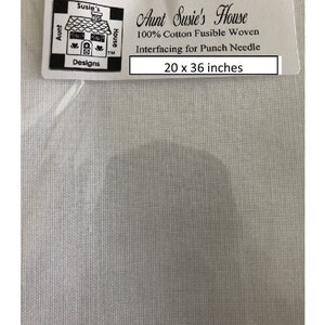 May include: White cotton fabric with a label that reads "Aunt Susie's House 100% Cotton Fusible Woven Interfacing for Punch Needle 20 x 36 inches".