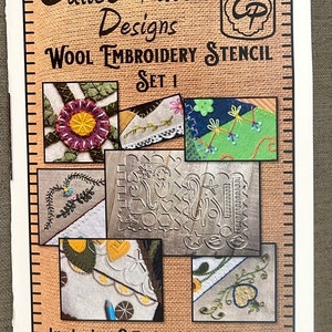 May include: Calico Patch Designs Wool Embroidery Stencil Set 1.  A close-up of a package featuring a variety of wool embroidery designs and two metal stencils. The package includes the text "Includes 2 Embroidery Stencils" and "Make hundreds of stitching designs".