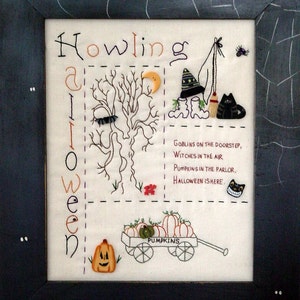 May include: A white fabric with black embroidery depicting a Halloween scene. The text "Howling Halloween" is stitched vertically on the left side. The scene includes a tree, a witch, a cat, a moon, a wagon full of pumpkins, and the text "Goblins on the doorstep, Witches in the air, Pumpkins in the parlor, Halloween is here."