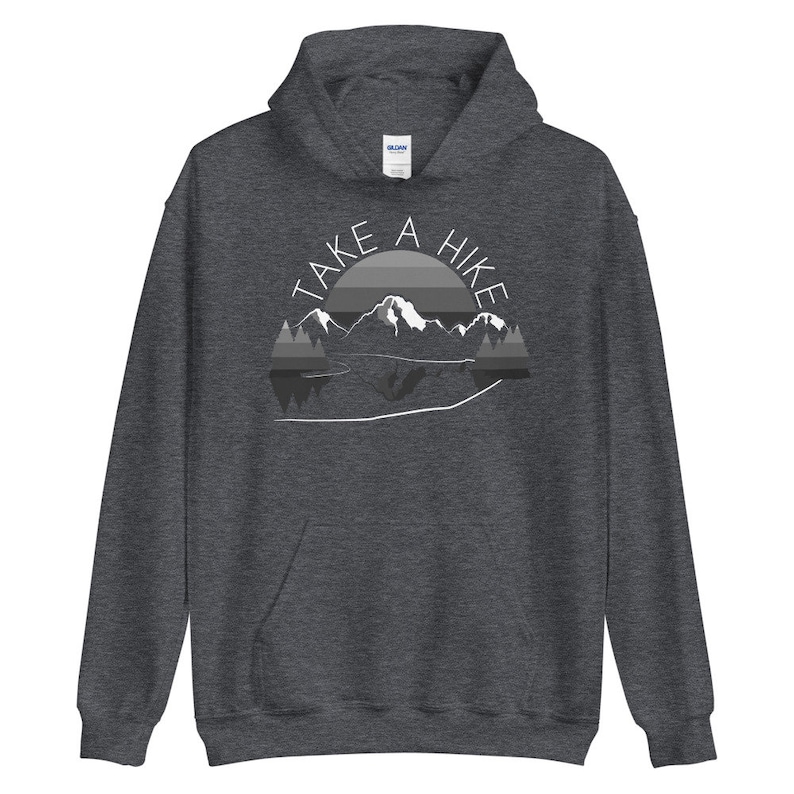 Puede incluir: Una sudadera con capucha gris oscuro con el texto "TAKE A HIKE" en letras blancas, una cordillera y un gr&aacute;fico de puesta de sol.