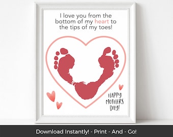 May include: A printable card with a pink heart shape containing two red baby footprints. The text reads "I love you from the bottom of my heart to the tips of my toes! Happy Mothers Day!"