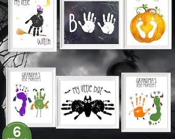 May include: Six framed Halloween-themed prints. Designs include a witch, a bat, a pumpkin, and monsters, all created with handprints and footprints. Text includes "My little Witch", "B", "My first Halloween", "Grandpa's little monsters", "My little bat", and "Grandma's little monsters".
