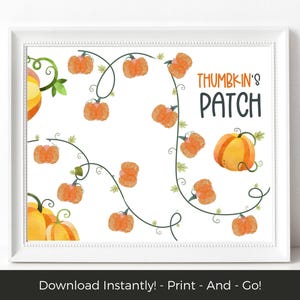 May include: A framed print with a pumpkin patch design. The artwork depicts orange pumpkins on green vines against a white backdrop. The words "Thumbkin's Patch" are displayed in a playful font. The print is in a white frame.