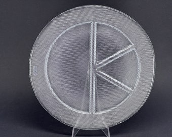 May include: A clear glass serving plate with a textured surface and a divided center section. The plate is divided into four sections, with three of the sections being pie-shaped and the fourth section being a larger circle.