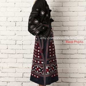 May include: A black embroidered linen blouse with a long, dark blue skirt featuring a geometric pattern. The skirt has a red and white design. The model is wearing brown heeled sandals. etsy.com/shop/HelenCloth Real Photo