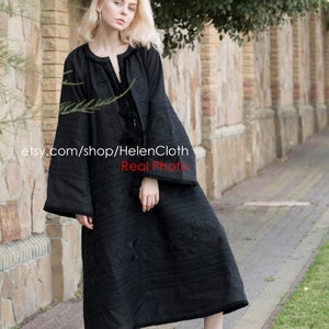 May include: A black embroidered dress with long sleeves and a loose fit. The dress has a geometric pattern and a tassel detail at the neckline. The model is wearing white sneakers. etsy.com/shop/HelenCloth Real Photo
