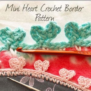May include: A close-up of a crochet border with a mini heart pattern. The border is made with light blue and pink yarn. The text "Mini Heart Crochet Border Pattern" is visible at the top of the image.