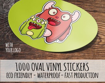 Könnte beinhalten: 1000 ovale Vinyl-Aufkleber mit grünem Hintergrund und zwei Comic-Monster. Die Monster sind rot und grün und haben große Augen und Münder. Der Text "WITH YOUR LOGO" befindet sich am unteren Rand des Bildes.