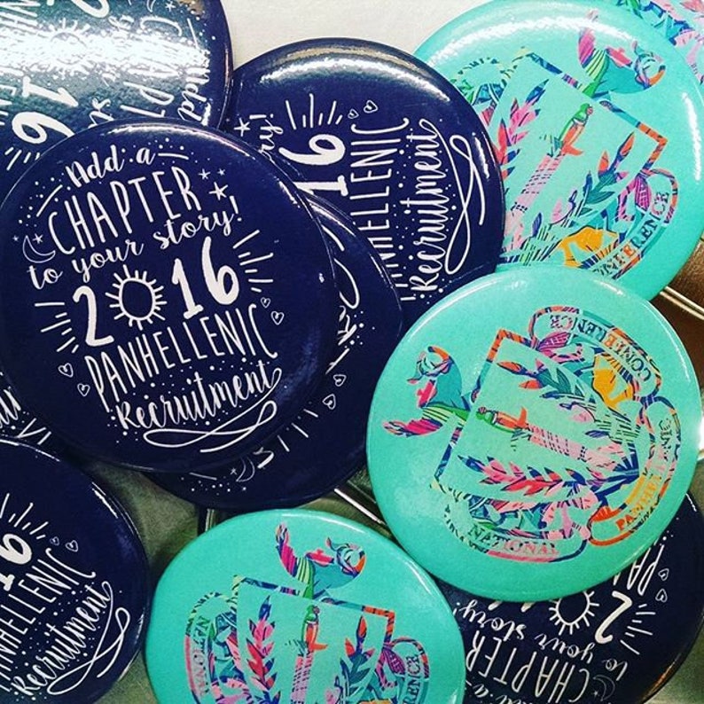 May include: A collection of blue and turquoise round buttons with white text and designs. The text on the buttons reads "Add a Chapter to your story! 2016 Panhellenic Recruitment".
