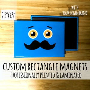 May include: A blue rectangle magnet with a cartoon face with a mustache. The magnet is 2.5 inches by 3.5 inches. The text "WITH YOUR LOGO/BRAND" is printed on the magnet. The text "CUSTOM RECTANGLE MAGNETS PROFESSIONALLY PRINTED & LAMINATED" is printed below the magnet.