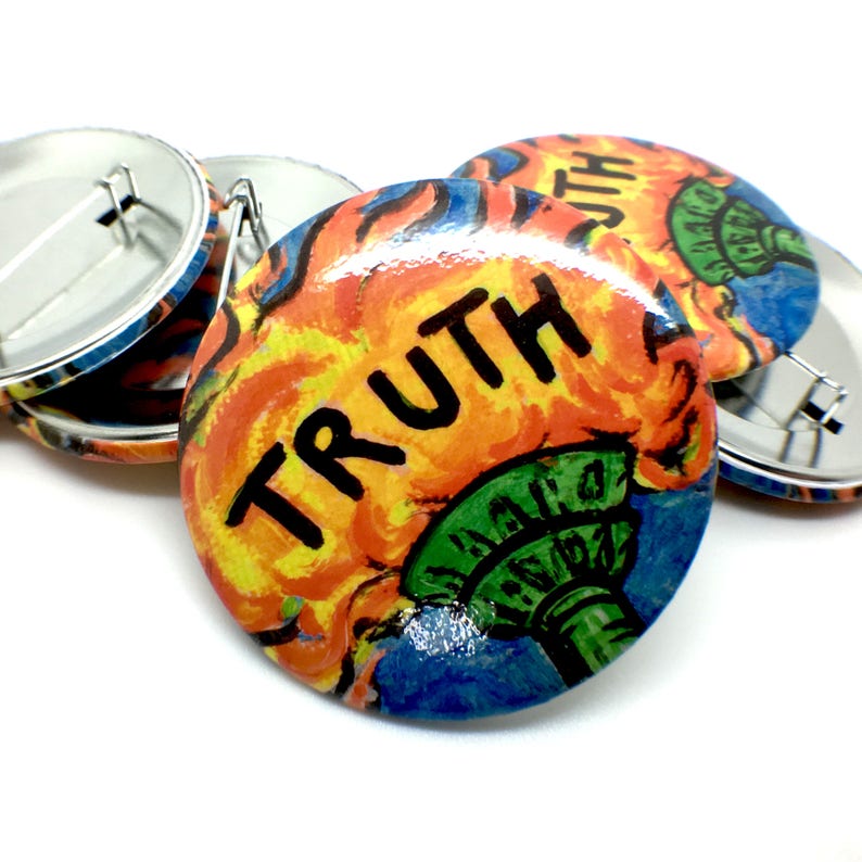 May include: A set of four 1-inch button pins with a colorful design featuring a torch with flames and the word "TRUTH" in black lettering. The torch is green and blue with yellow and orange flames.