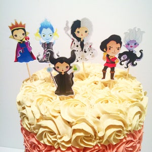 May include: A multi-tiered cake decorated with buttercream frosting in shades of pink, peach, and white. The cake is topped with six Disney villain cake toppers, including Maleficent, Cruella de Vil, Ursula, and the Evil Queen.