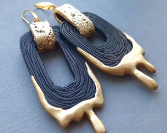 Large black and gold abstract geometrical mismatched earrings with oversized links