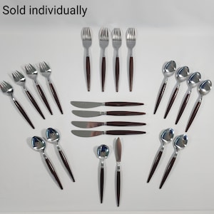 May include: A set of 18 pieces of silverware with brown handles. The set includes forks, spoons, and knives. The silverware is sold individually.