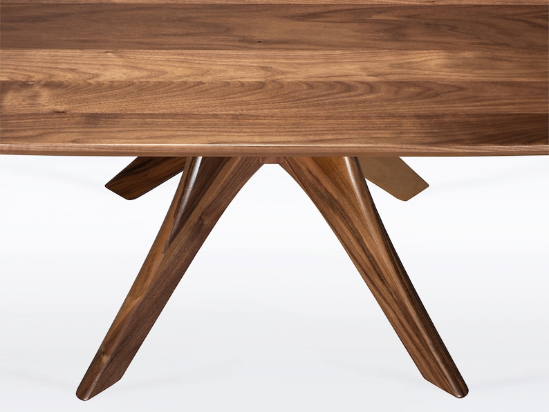 Rectangular coffee table handmade in solid walnut wood. This table has a pedestal base with four curved legs connected at the center. The look of the table is midcentury modern, Danish modern and Scandinavian.  Available in a variety of sizes.