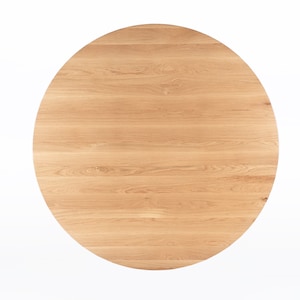 Round dining table handmade in solid white oak wood. This table has a pedestal base with four curved legs connected at the center. The look of the table is midcentury modern, Danish modern and Scandinavian.  The table available in a variety of sizes.
