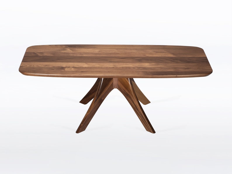 Rectangular coffee table handmade in solid walnut wood. This table has a pedestal base with four curved legs connected at the center. The look of the table is midcentury modern, Danish modern and Scandinavian.  Available in a variety of sizes.