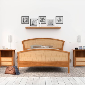 This is a handmade wooden bed with a curved headboard and footboard.  The headboard and footboard are inlaid with curved wood pieces that look like river rushes.  The bed is made with cherry and curly maple wood.