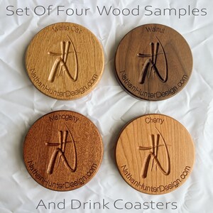 May include: Set of four round wooden coasters featuring different wood types: white oak, walnut, mahogany, and cherry. Each coaster has a carved design and the text "NathanHunterDesign.com".