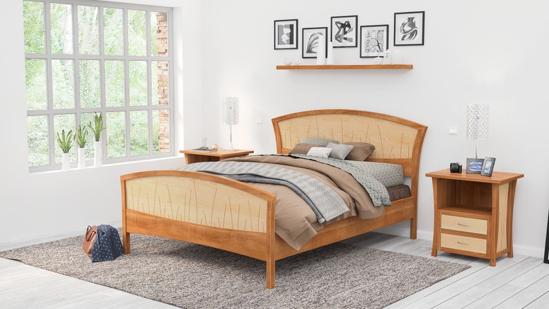 This is a handmade wooden bed with a curved headboard and footboard.  The headboard and footboard are inlaid with curved wood pieces that look like river rushes.  The bed is made with cherry and curly maple wood.