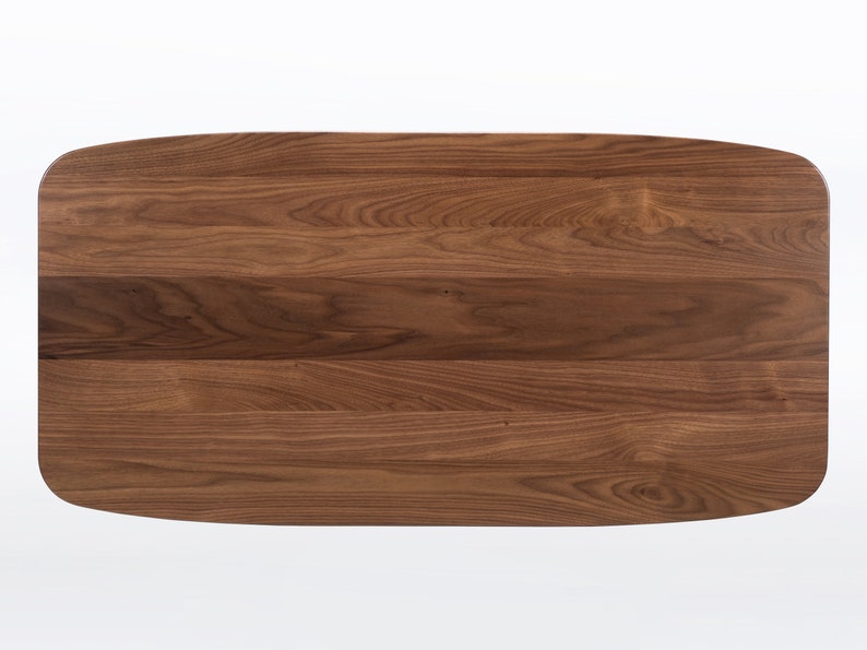 Rectangular coffee table handmade in solid walnut wood. This table has a pedestal base with four curved legs connected at the center. The look of the table is midcentury modern, Danish modern and Scandinavian.  Available in a variety of sizes.