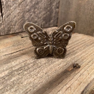 May include: A cast iron butterfly door knob with a distressed finish.