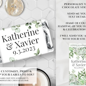 May include: A miniature chocolate bar wrapper with the names "Katherine & Xavier" and the date "9.3.2023" printed on it. The wrapper has a white background with green leaf accents. The text "Personalize your chocolate stickers!" is also visible.