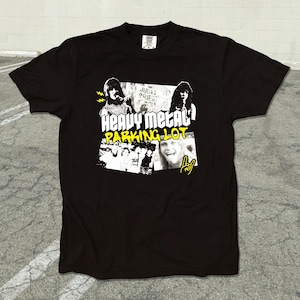 May include: Black t-shirt with a yellow graphic print of a band called "Judas Priest" and the text "Heavy Metal Parking Lot".