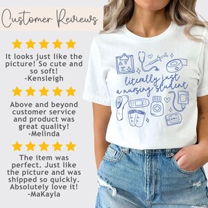 May include: White t-shirt with a blue graphic design that says "literally just a nursing student". The graphic includes medical symbols like a stethoscope, thermometer, bandages, and a heart.
