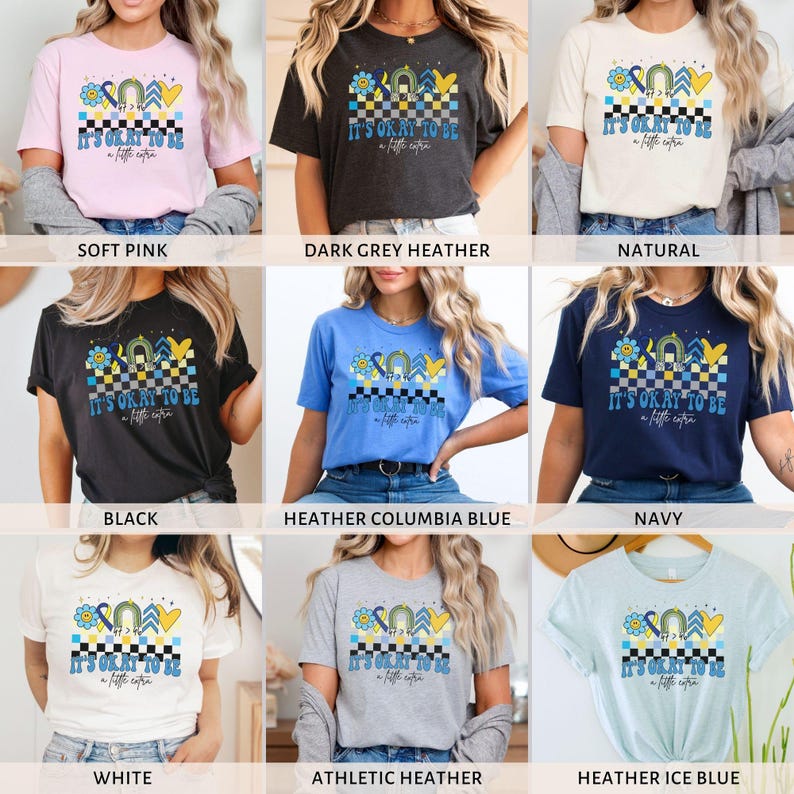 Pu&ograve; includere: Una collezione di t-shirt in vari colori con un design grafico con il testo "It's okay to be a little extra". Il design include un motivo a scacchi, un arcobaleno, un cuore e una stella gialla.