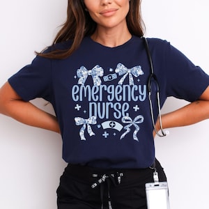 May include: A navy blue t-shirt with a white and blue floral design and the text "emergency purse".