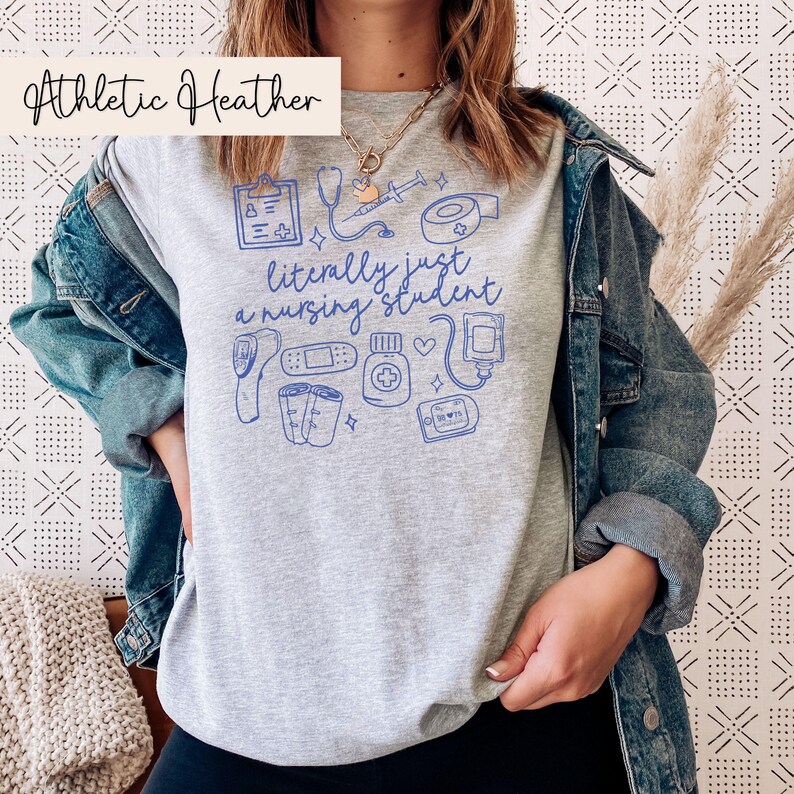 May include: A heather gray t-shirt with a blue graphic of medical supplies and the text "literally just a nursing student".
