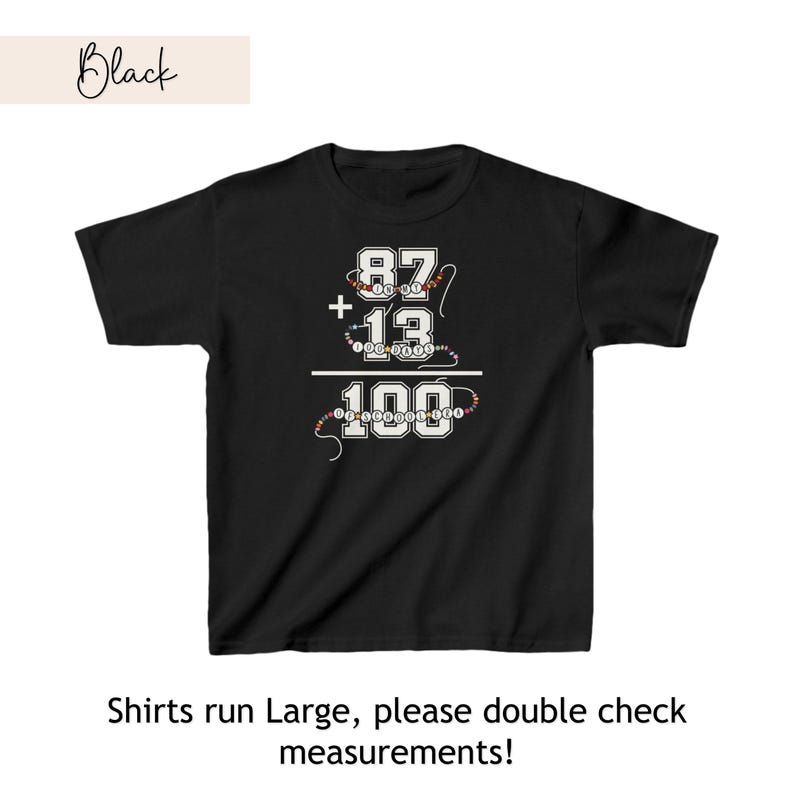 May include: Black t-shirt with a white graphic of a math equation: 87 + 13 = 100. The numbers are surrounded by colorful beads.
