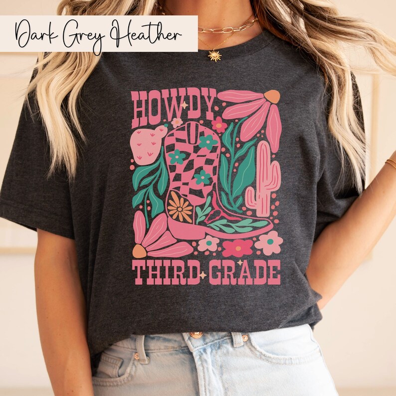 a woman wearing a t - shirt that says howdy third grade