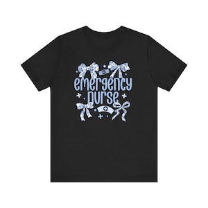 May include: Black t-shirt with a blue and white design featuring the text "emergency nurse" and decorative bows.